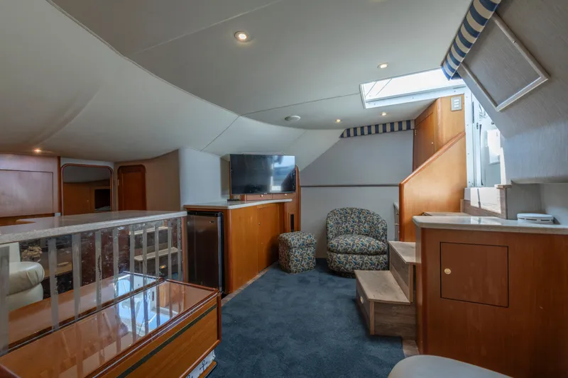 Slide: The Image of Interior of 1999 Ocean Yachts 48 Express, featuring cozy seating and modern amenities. - 42