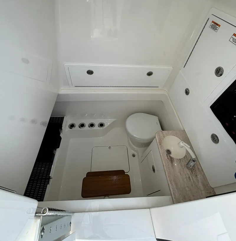 Slide: The Image of 2022 Valhalla V-37 boat interior bathroom with toilet, sink, and storage compartments. - 4