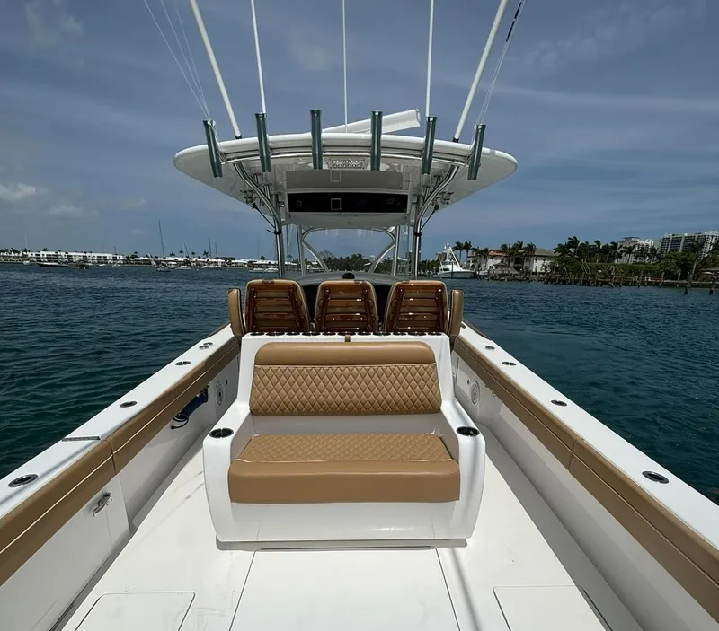 Slide: The Image of 2022 Valhalla Boatworks V-37 on water, featuring tan seating and sleek design. - 8