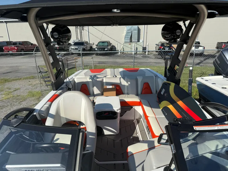 Slide: The Image of 2017 Malibu Wakesetter 21 VLX interior with seating and wakeboard, parked outdoors. - 4