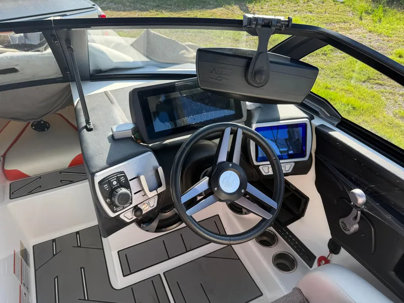 Slide: The Image of 2017 Malibu Wakesetter 21 VLX boat dashboard with steering wheel and digital displays. - 5