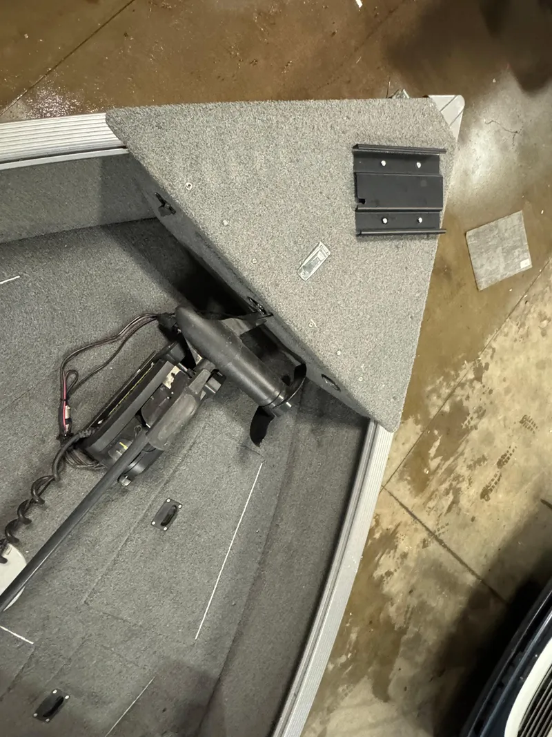 Slide: The Image of 2017 Lund 1850 Impact XS boat interior with trolling motor and carpeted deck. - 13