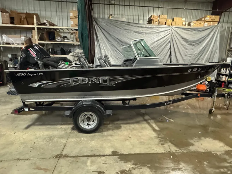 Slide: The Image of 2017 Lund 1850 Impact XS boat on trailer in a garage setting. - 3