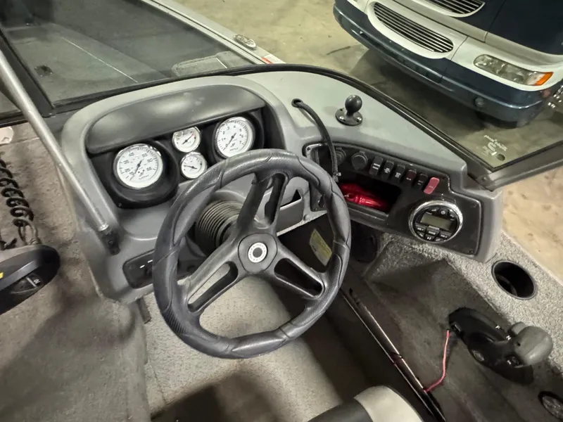 Slide: The Image of 2017 Lund 1850 Impact XS boat dashboard with steering wheel and gauges. - 8