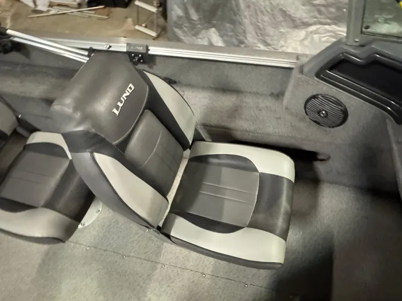 Slide: The Image of 2017 Lund 1850 Impact XS boat interior with gray and black seating. - 9