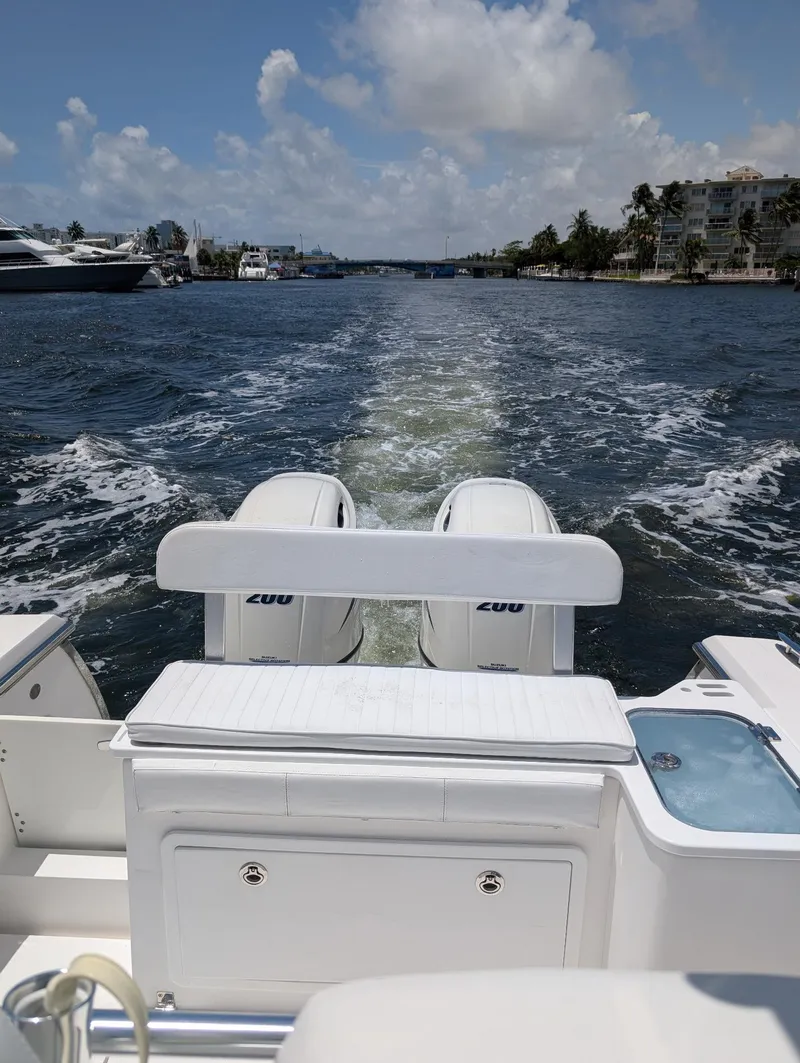Slide: The Image of 2016 Southport 272TE boat with dual engines cruising on a sunny day. - 10