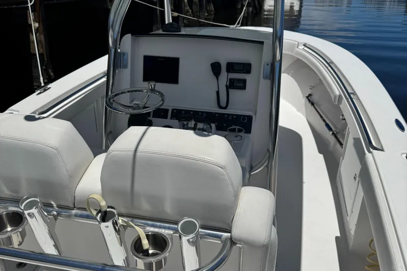 Slide: The Image of 2016 Southport 272TE boat interior with steering console and seating. - 13