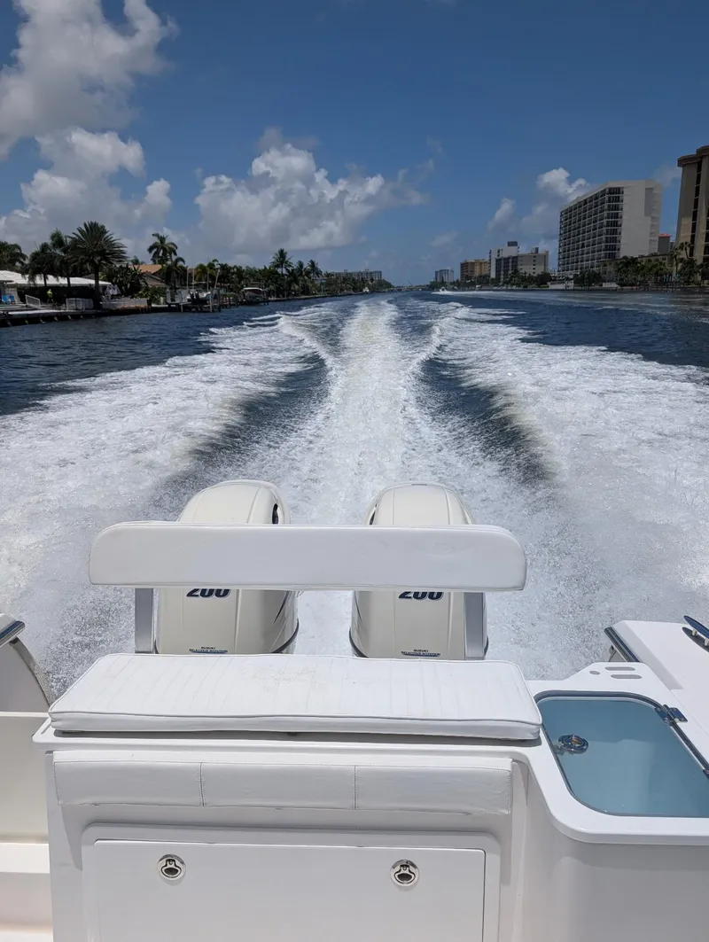 Slide: The Image of 2016 Southport 272TE boat cruising on a sunny day, leaving a wake behind. - 2