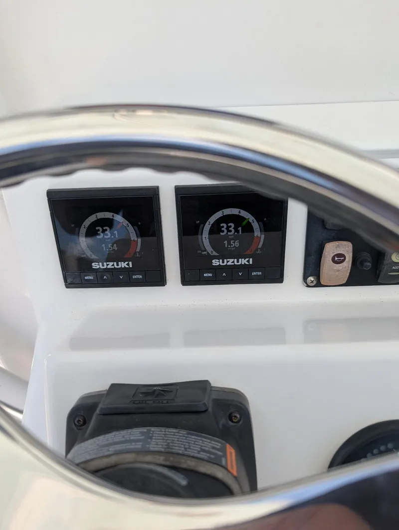 Slide: The Image of Close-up of 2016 Southport 272TE boat dashboard with Suzuki digital gauges. - 3