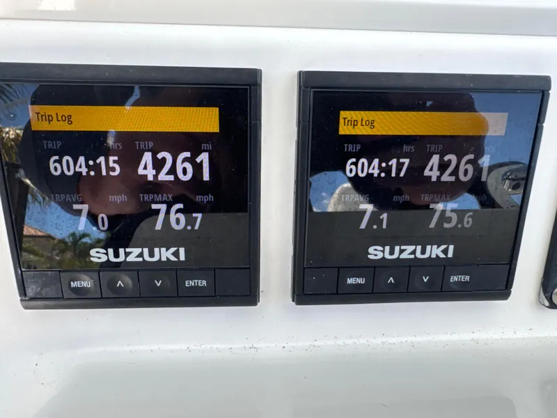 Slide: The Image of Digital displays on a 2016 Southport 272TE showing trip log data and Suzuki branding. - 7