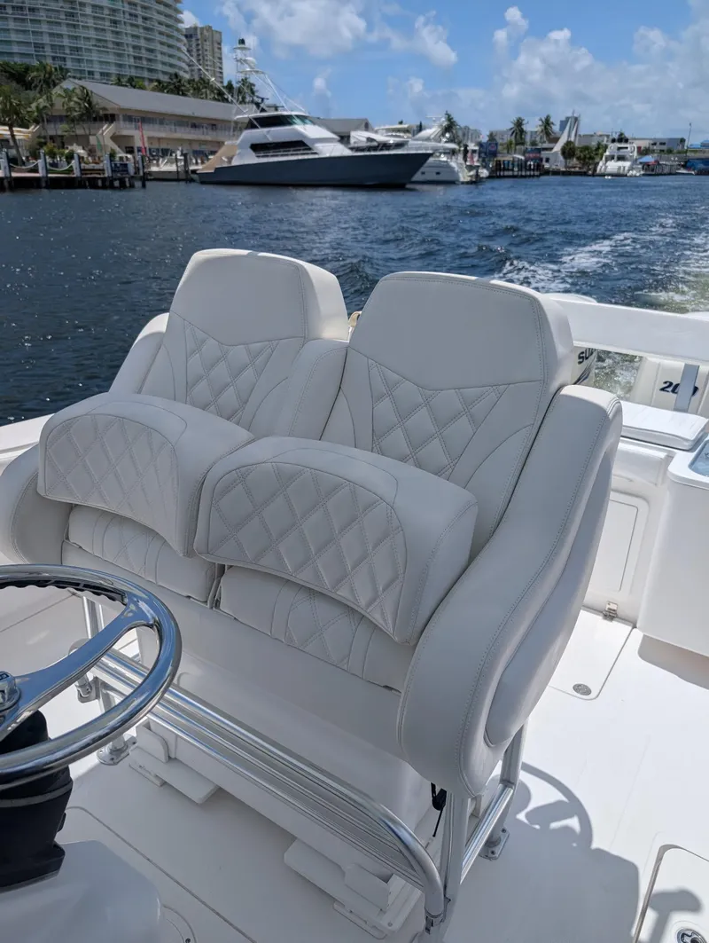 Slide: The Image of Luxurious seating on 2016 Southport 272TE boat with waterfront view. - 9