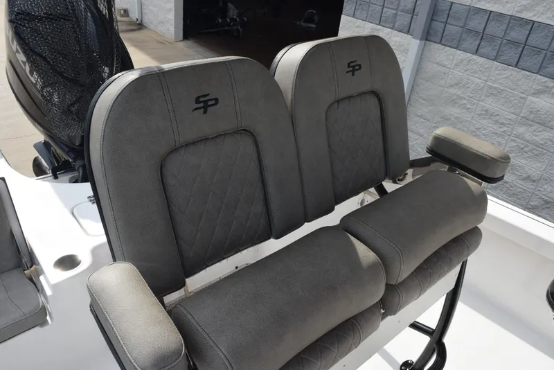 Slide: The Image of 2022 Sea Pro 228 Bay boat seats with gray upholstery and armrests. - 10