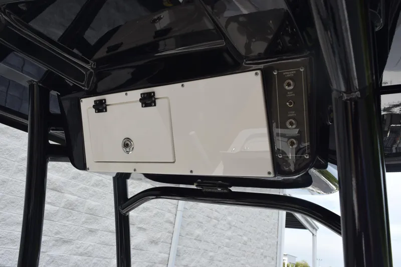 Slide: The Image of 2022 Sea Pro 228 Bay boat console with control panel and storage compartment. - 12