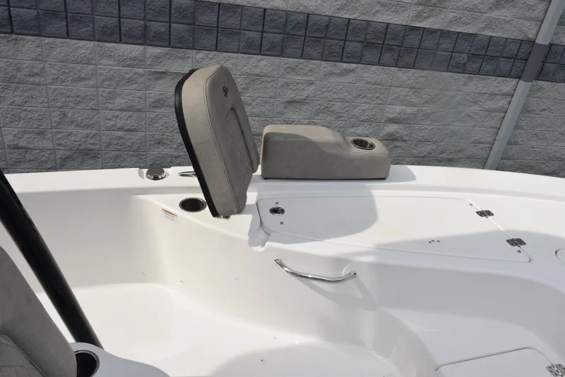 Slide: The Image of 2022 Sea Pro 228 Bay boat interior with seating and storage compartments. - 14