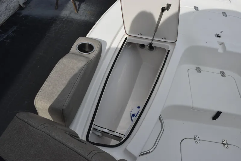 Slide: The Image of 2022 Sea Pro 228 Bay boat with open storage compartment and cup holder. - 18