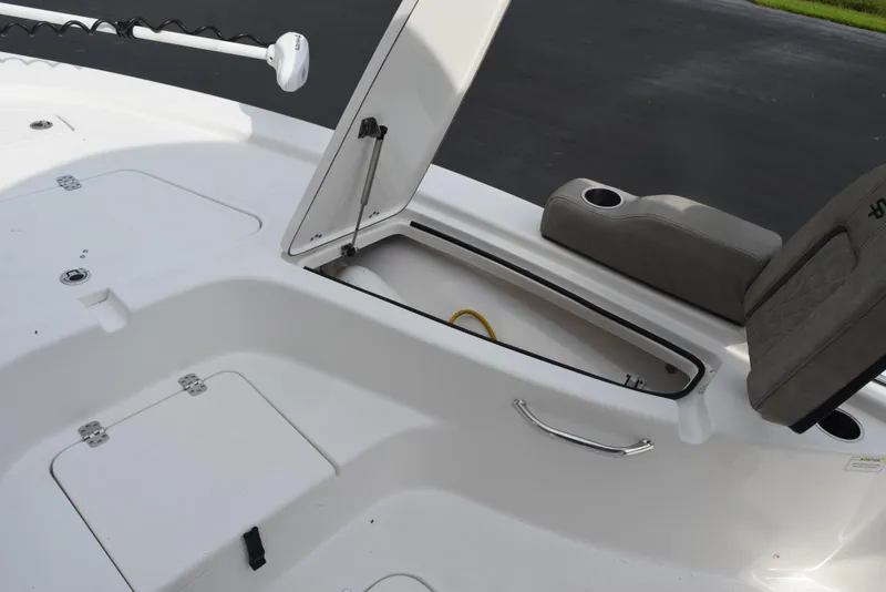 Slide: The Image of 2022 Sea Pro 228 Bay boat with open storage compartment and seating area. - 19