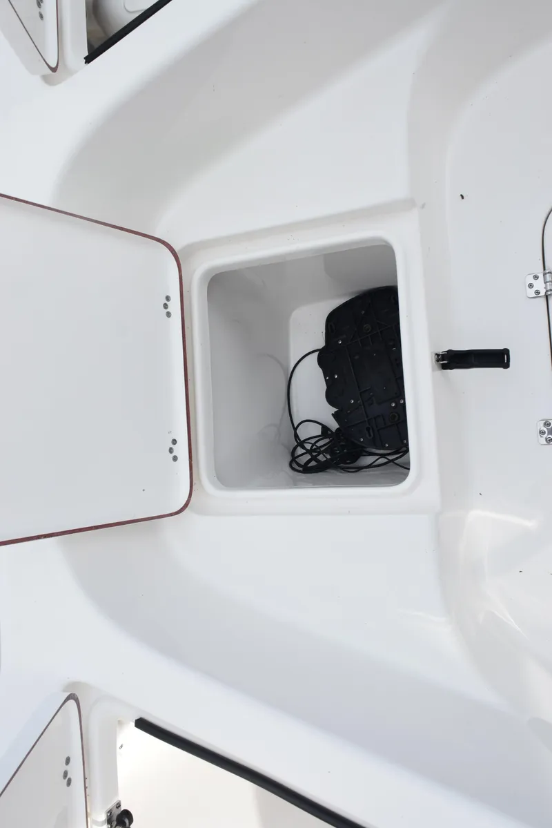 Slide: The Image of 2022 Sea Pro 228 Bay boat storage compartment with wiring visible. - 20