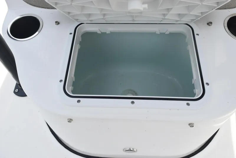 Slide: The Image of Open storage compartment on 2022 Sea Pro 228 Bay boat, featuring cup holders. - 22