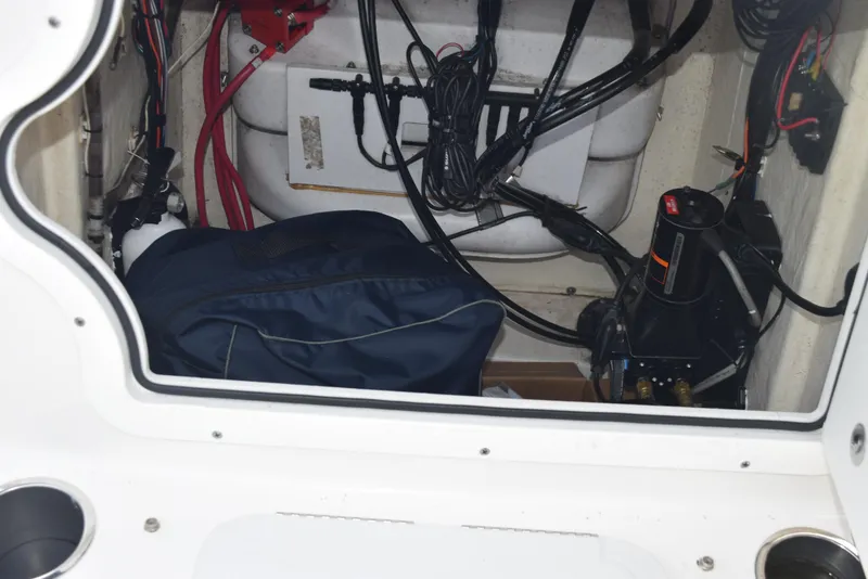 Slide: The Image of Interior view of 2022 Sea Pro 228 Bay boat's storage compartment with wiring and equipment. - 25
