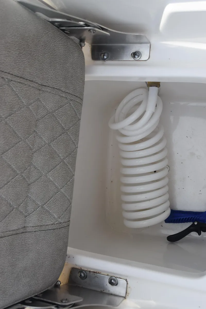 Slide: The Image of Storage compartment with coiled hose in 2022 Sea Pro 228 Bay boat. - 26
