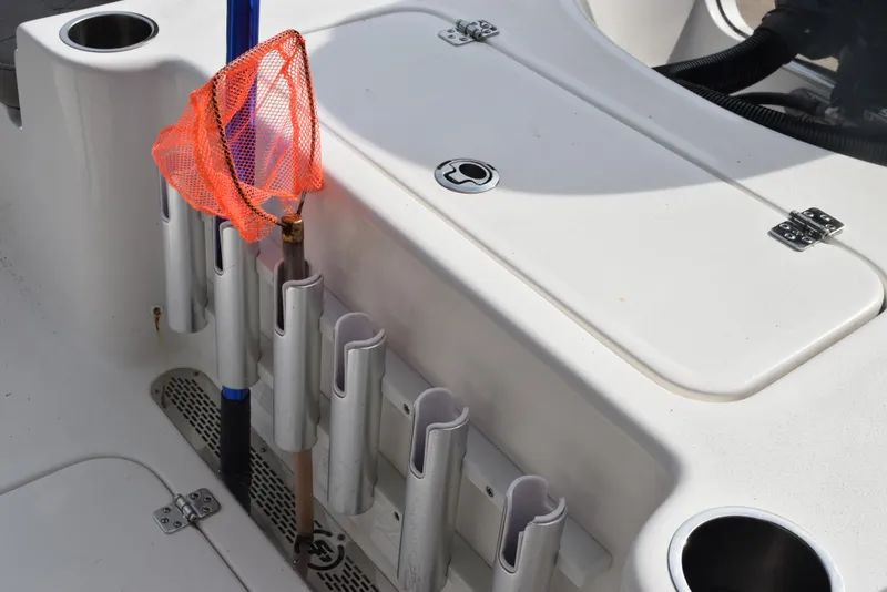 Slide: The Image of 2022 Sea Pro 228 Bay boat deck with fishing rod holders and storage compartments. - 28
