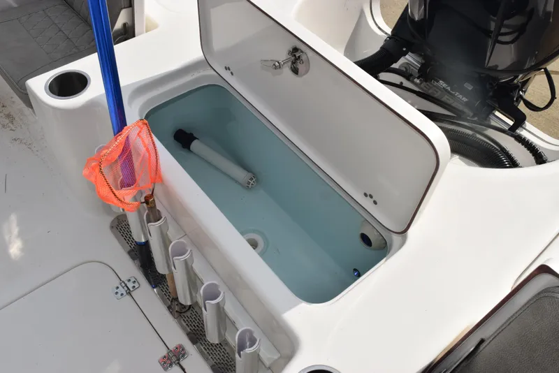 Slide: The Image of 2022 Sea Pro 228 Bay boat livewell with fishing rod holders and net. - 29
