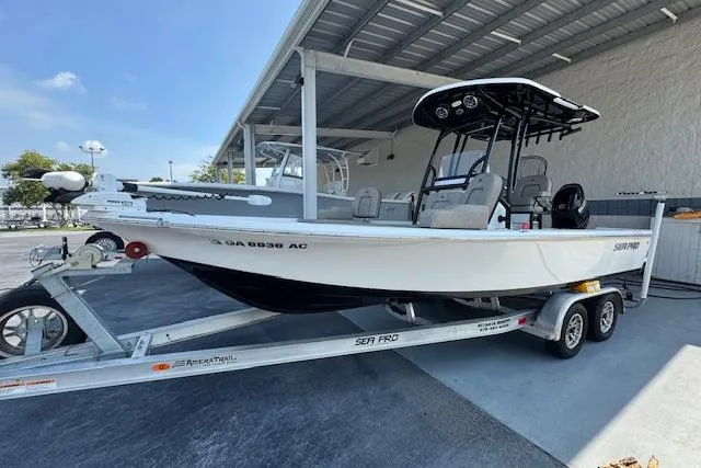 Slide: The Image of 2022 Sea Pro 228 Bay boat on trailer under a metal canopy. - 32