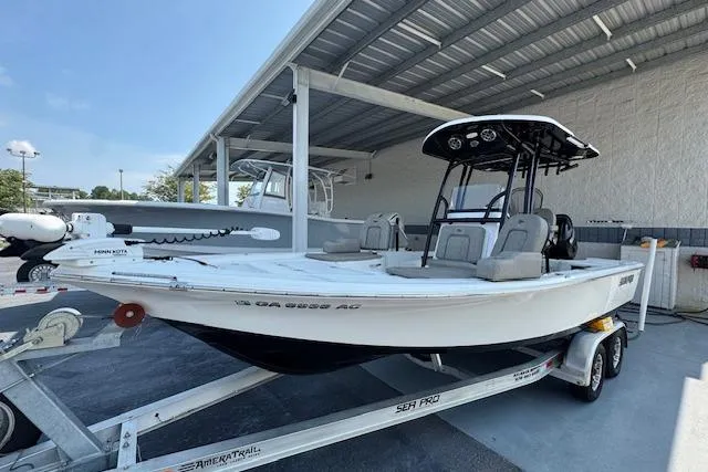 Slide: The Image of 2022 Sea Pro 228 Bay boat on trailer under a metal canopy. - 33
