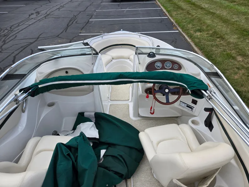 Slide: The Image of Interior of a 1998 Chris-Craft 210 Bowrider boat with white seating and steering console. - 11