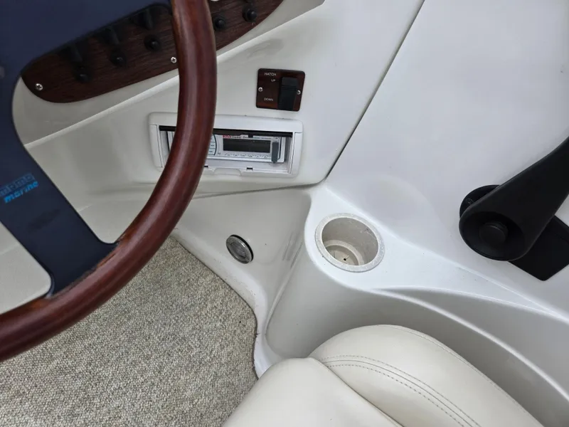Slide: The Image of Interior view of a 1998 Chris-Craft 210 Bowrider, showing carpet and metal rods. - 13