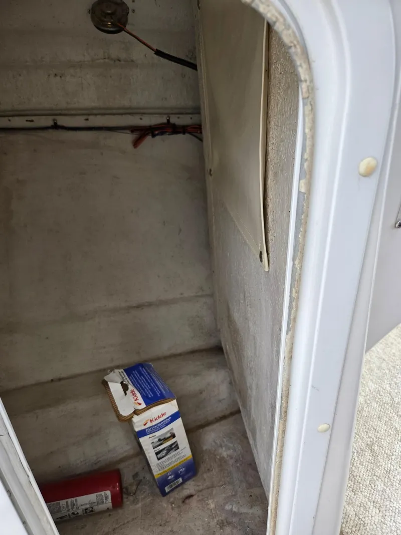 Slide: The Image of 1998 Chris-Craft 210 Bowrider dashboard with gauges and wooden steering wheel. - 15