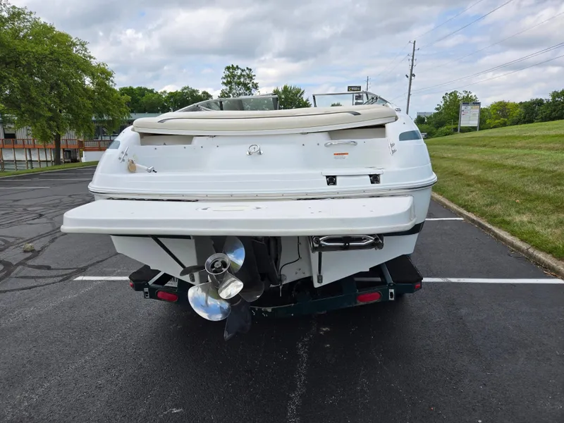 Slide: The Image of 1998 Chris-Craft 210 Bowrider boat parked near a snowy lakeside. - 2
