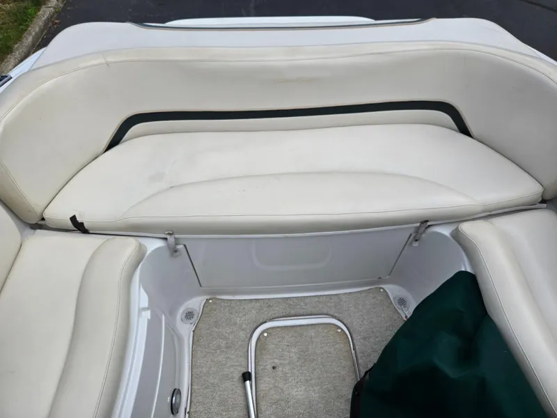Slide: The Image of 1998 Chris-Craft 210 Bowrider interior with seating, steering wheel, and lake view. - 21