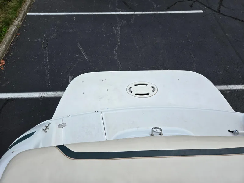 Slide: The Image of 1998 Chris-Craft 210 Bowrider interior with white seating and carpeted floor. - 23