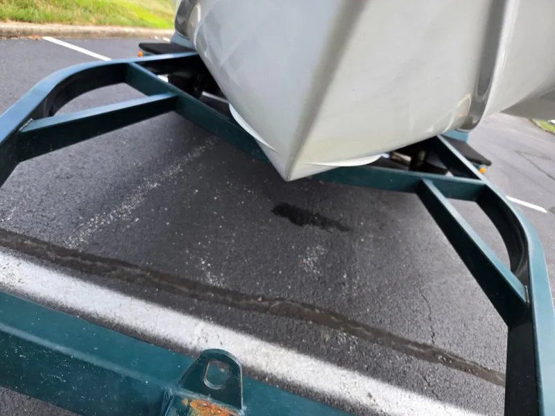 Slide: The Image of 1998 Chris-Craft 210 Bowrider on a green trailer, parked on asphalt. - 7