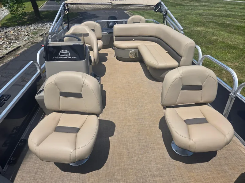 Slide: The Image of 2023 Sun Tracker Bass Buggy 18 DLX pontoon boat with beige seating and spacious deck. - 10