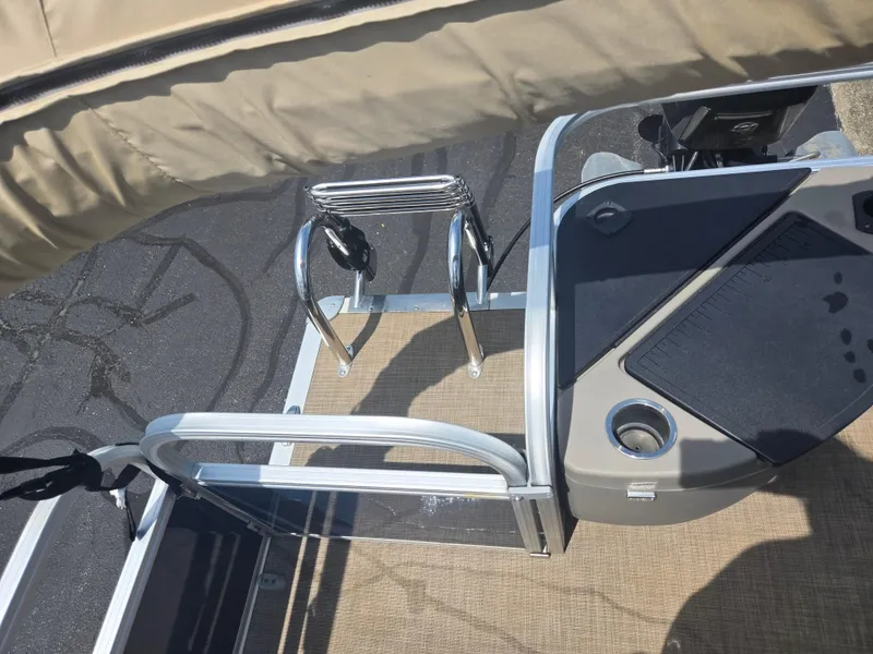 Slide: The Image of 2023 Sun Tracker Bass Buggy 18 DLX pontoon boat deck with ladder and console. - 15