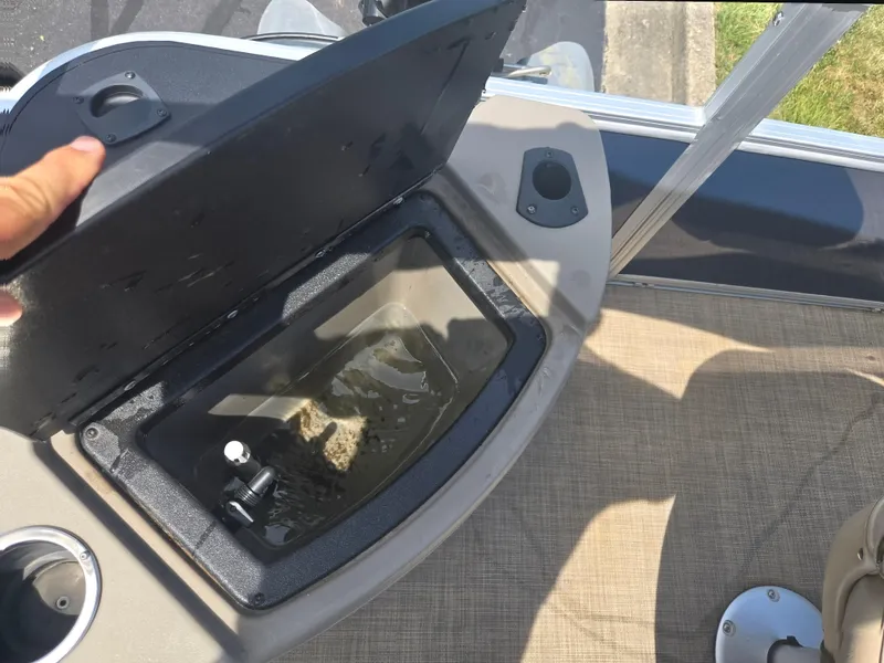 Slide: The Image of 2023 Sun Tracker Bass Buggy 18 DLX livewell with open lid and water inside. - 16