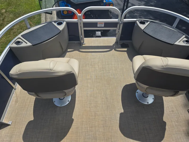 Slide: The Image of 2023 Sun Tracker Bass Buggy 18 DLX interior with two beige swivel seats. - 21