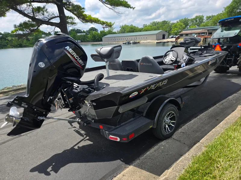 Slide: The Image of 2022 Vexus AVX181 boat with Mercury engine on trailer by a lake. - 1