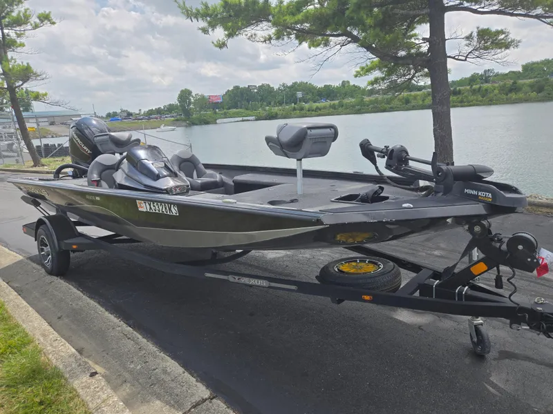 Slide: The Image of 2022 Vexus AVX181 boat on trailer by a lake, featuring Minn Kota motor. - 10