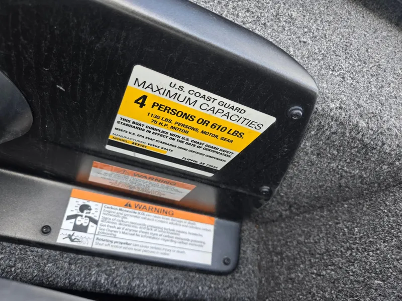 Slide: The Image of U.S. Coast Guard capacity label on 2022 Vexus AVX181 boat, indicating 4-person or 610 lbs limit. - 14