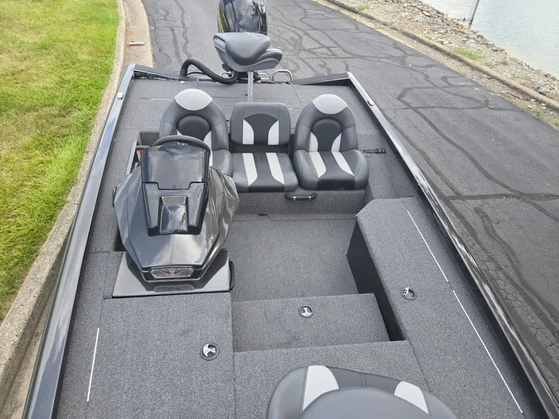 Slide: The Image of 2022 Vexus AVX181 boat interior with seating and control console, parked near water. - 19