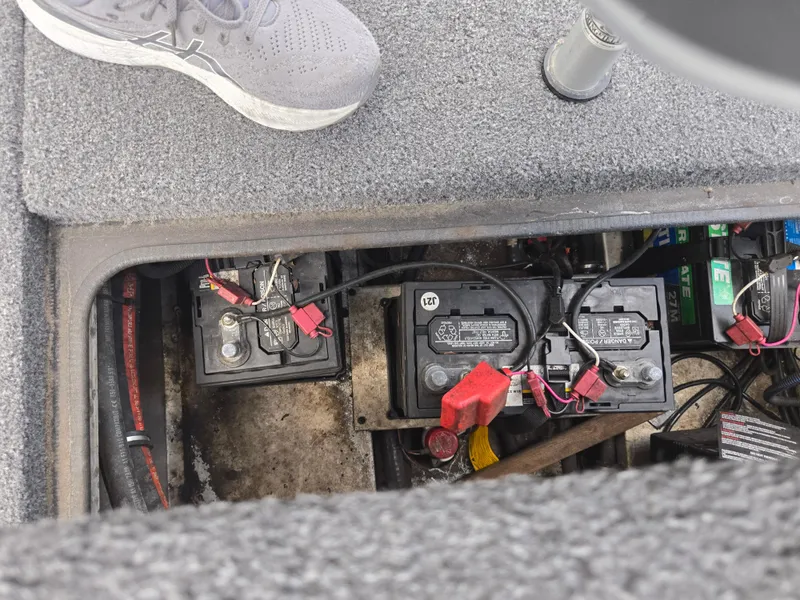 Slide: The Image of 2022 Vexus AVX181 boat battery compartment with visible wiring and components. - 23