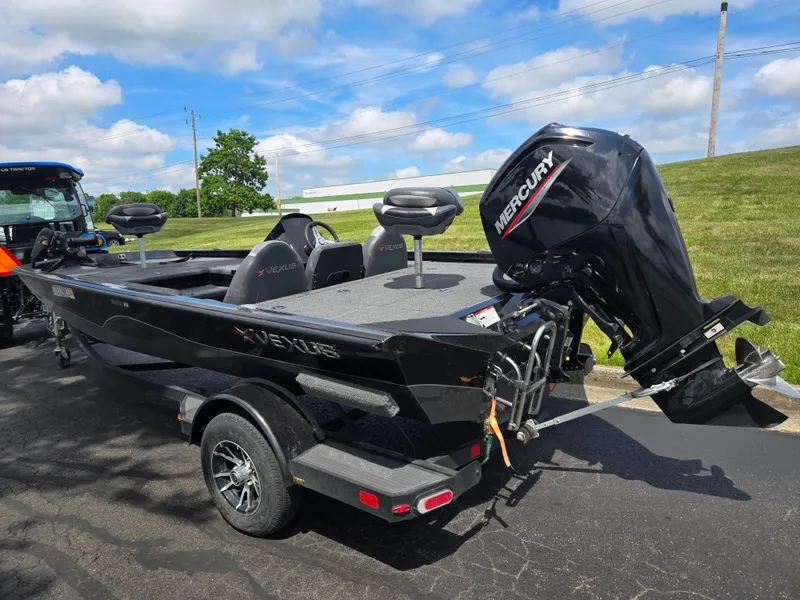 Slide: The Image of 2022 Vexus AVX181 boat with Mercury engine on a trailer, parked outdoors. - 3