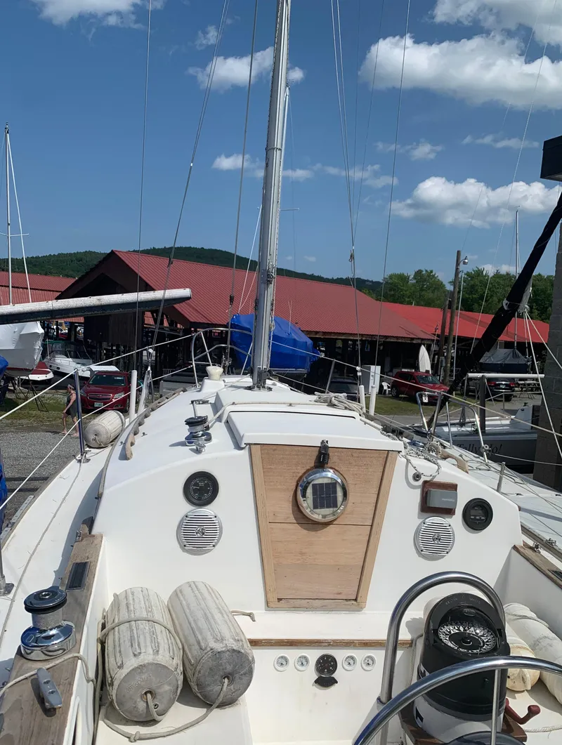 Slide: The Image of 1979 Sabre 28-2 sailboat deck view with clear sky and marina background. - 14
