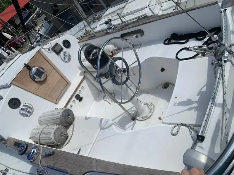 Slide: The Image of 1979 Sabre 28-2 sailboat cockpit with steering wheel and nautical equipment. - 19