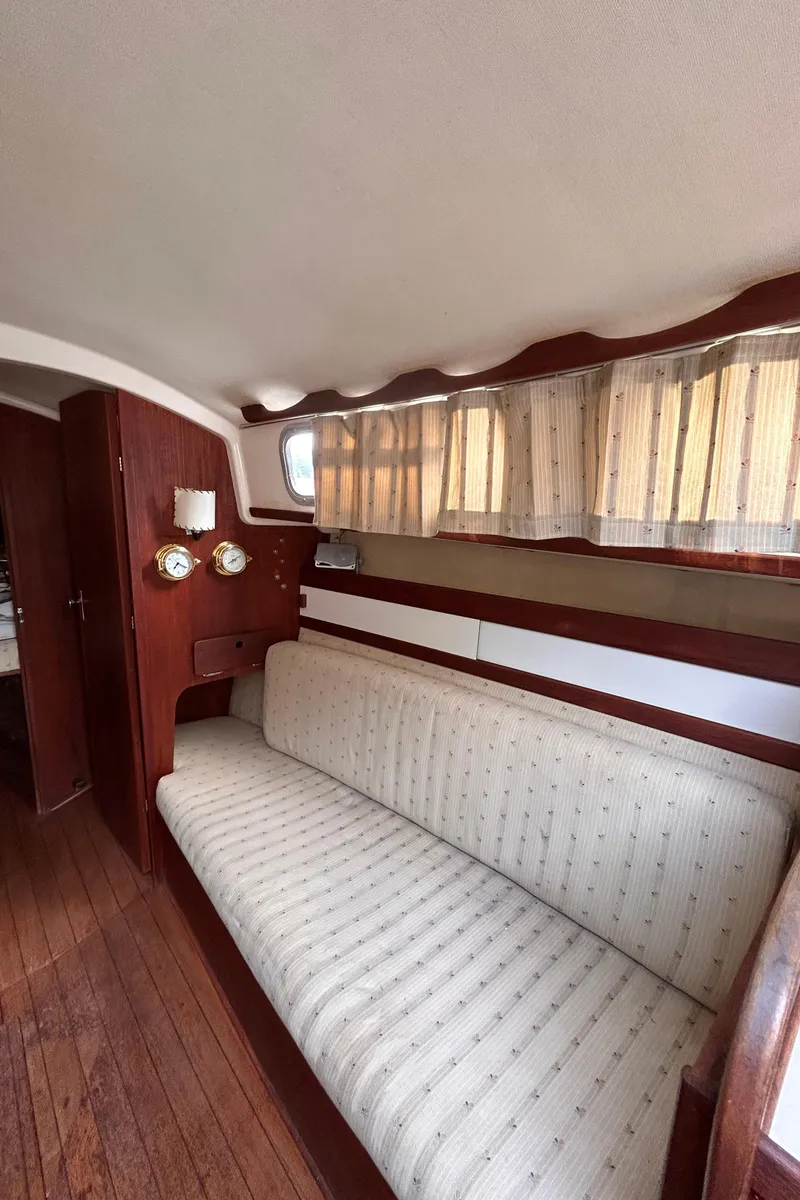 Slide: The Image of Interior of 1979 Sabre 28-2 sailboat with wooden flooring and cushioned seating. - 22