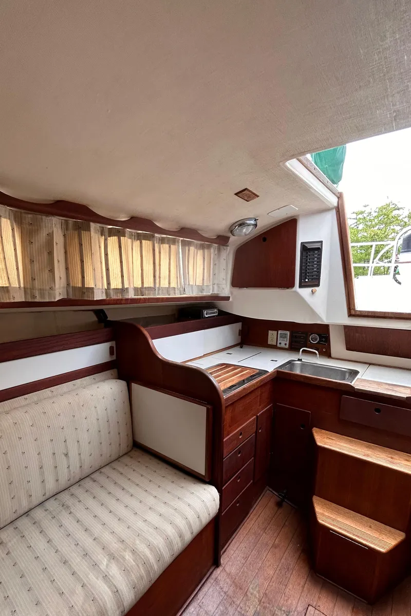 Slide: The Image of 1979 Sabre 28-2 sailboat interior with kitchenette and seating area. - 23