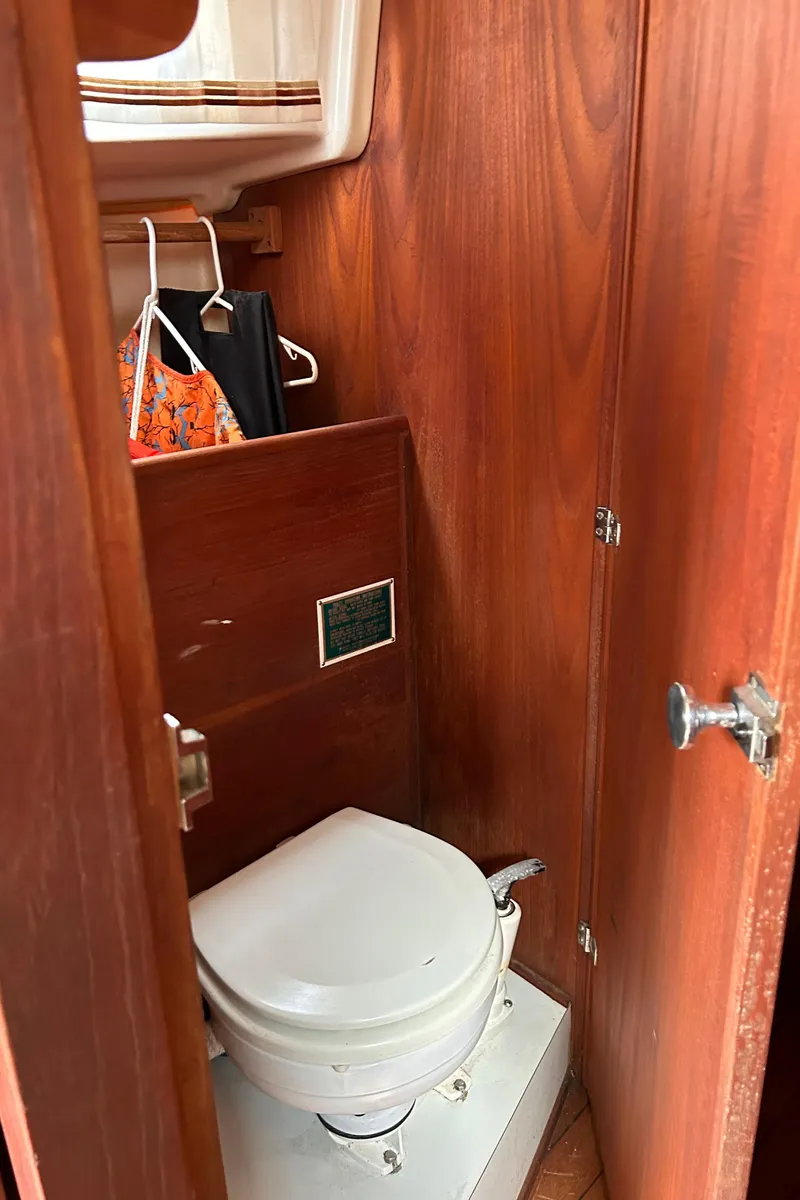 Slide: The Image of 1979 Sabre 28-2 sailboat interior with wooden cabinetry and marine toilet. - 27